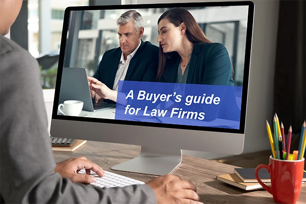 Law firm professionals reviewing a legal document management software buyer's guide on a computer screen
