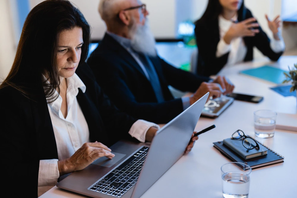 Law firm professionals collaborating on documents during a business meeting